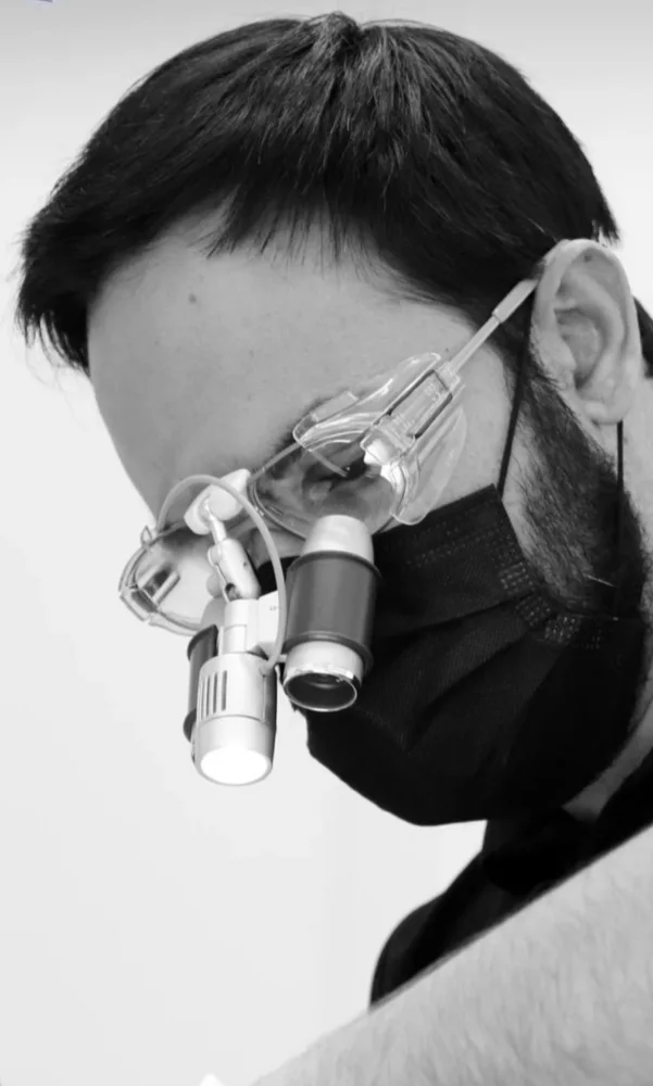 Dr Miguel Romero using magnification while carrying out clinical dental treatment in Marbella