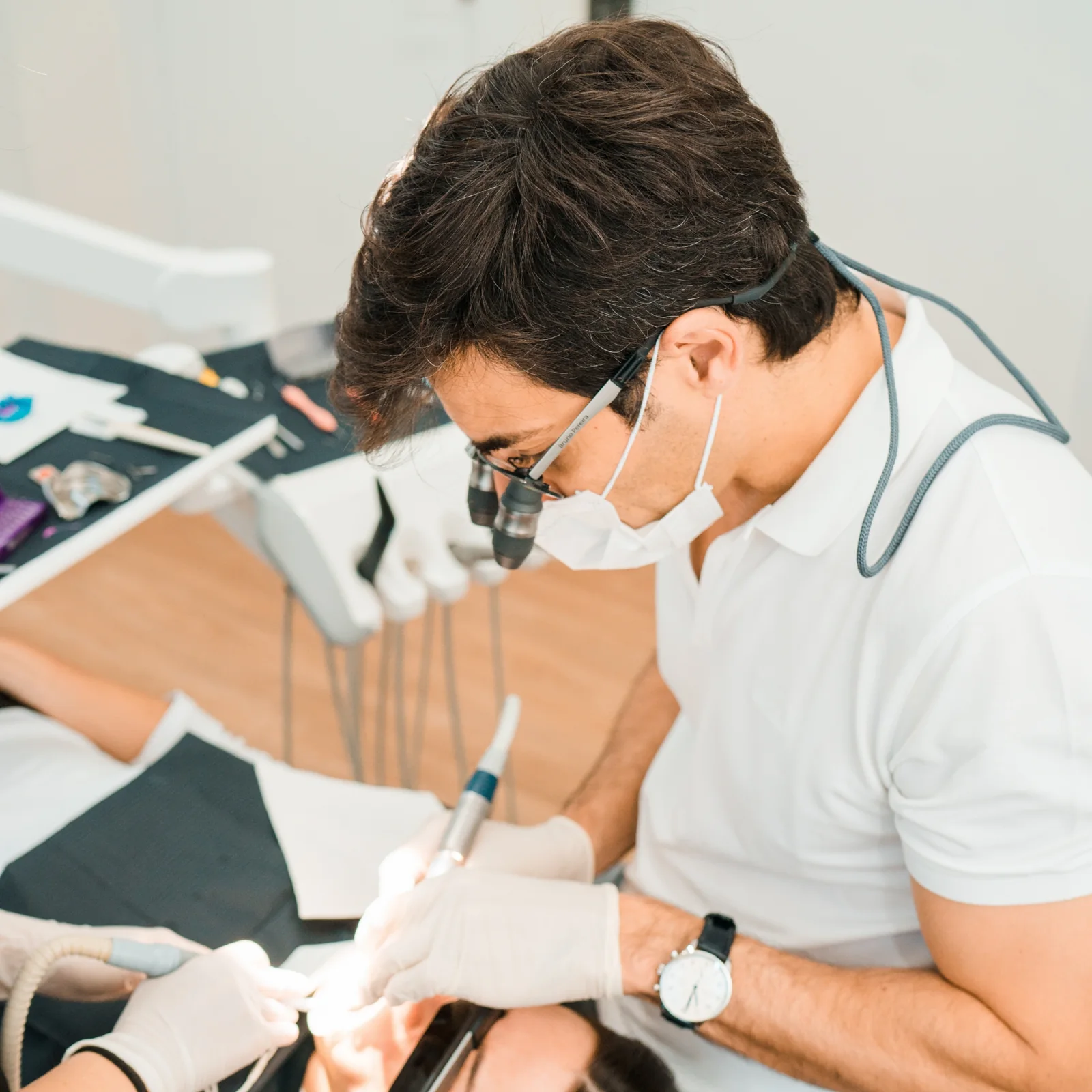 Dr Bruno Pereira carrying out precise dental treatment with magnification
